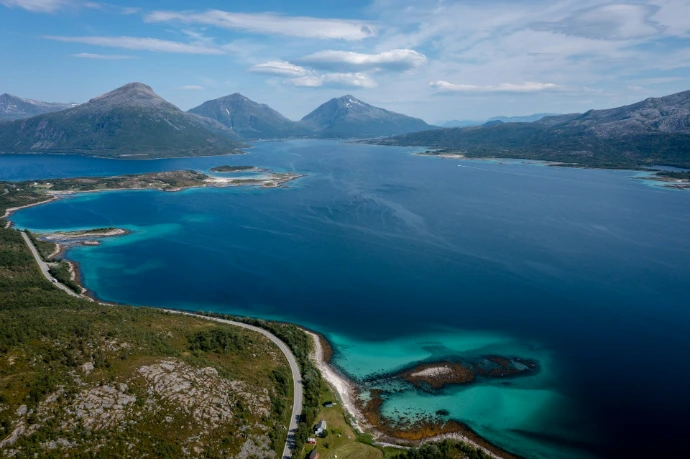 aerial view of blue sea and green mountains during daytime